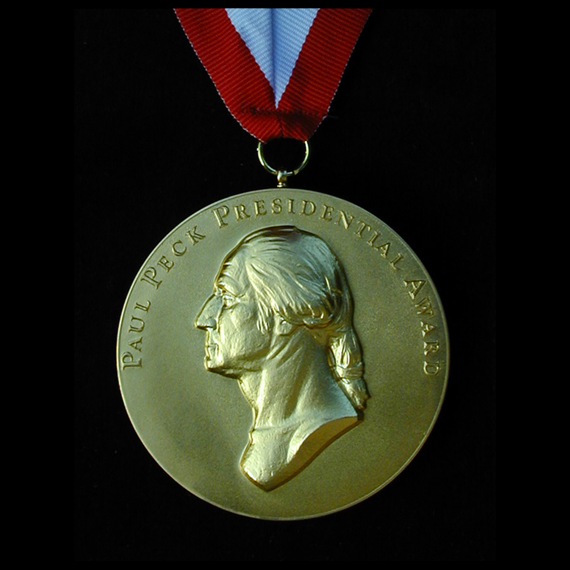 Gold Paul Peck Presidential Award medal on ribbon